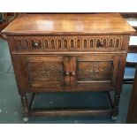 A small oak sideboard, single drawer above two cupboard doors, with carved lozenge decoration, on
