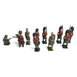 A collection of lead toy Scottish soldiers, together with two cowboys and a number of resin toy