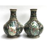 A pair of Chinese famille verte octagonal vases, each having four panels depicting figures,