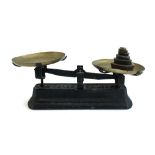 A cast iron set of scales with brass trays and full set of weights, marked Force 5 Kilog