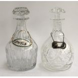 Two heavy glass decanters with whiskey labels (one silver, one ceramics)