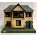 A Merigold Brothers 'Toyland' mock tudor dolls house; together with a foldable toy garage