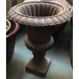 A cast iron garden urn on square plinth base, 55cmH