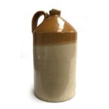A stoneware flagon with loop handle, marked 'Mitchell Toms & Co. ltd, distillery, Chard', 41cmH