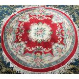 A floral wool centre rug, 180cmD; together with a green rug, 1560x120cm