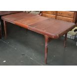 A mid-century extending kitchen table with bolt-on legs