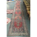 A very long runner rug, section removed for fireplace, 630x96cm; together with a prayer mat,