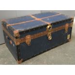 A vintage travel trunk with metal bracing