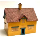 A wooden painted dolls house with removable roof