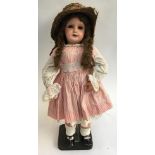 A French SFBJ 301 doll with blue sleeping eyes in pinstripe dress