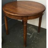 A solid oak circular extending dining table, with spare leaf, 90cmD