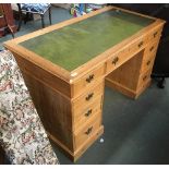 A pine kneehole desk, green leather skiver, over three drawers, the kneehole flanked by a further