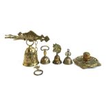 A brass wall mounted dinner bell, 'OCEM-MEAM-A...-ME...TANGIT', three small table bells and an