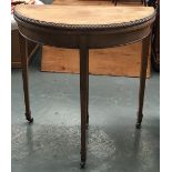 A faded mahogany demilune card table, fold-over top on square tapered legs, with spayed feet and