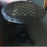 An ebonised papier mache and abalone inlay tip-top chess table, shaped top on baluster turned
