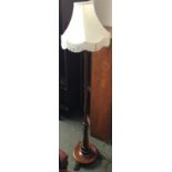 An attractive standard lamp with turned base on paw feet, 150cmH