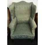 A substantial 19th century wingback armchair, shaped top rail, on cabriole legs