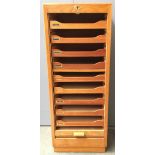 A mid-century oak filing cabinet, with nine slides, with roll-up tambour, 117cmH