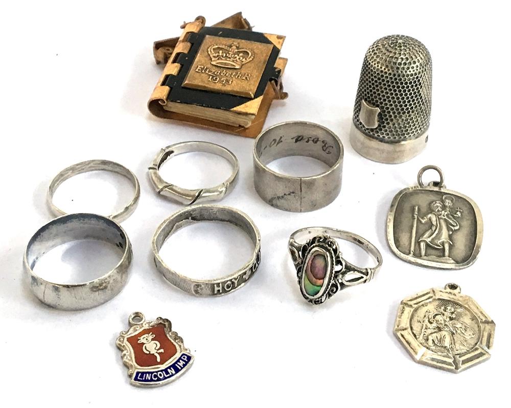 Six silver rings, two silver St Christophers, silver thimble, etc