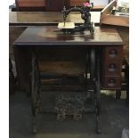 A Willcox & Gibbs sewing machine table with machine, with dropflap 73cmW
