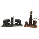 A pair of carved hardwood elephant bookends; wooden bookends in the form of cannons (af); together