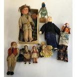 A collection of dolls, to include papier mache, cloth and composition, as well as a carved wooden