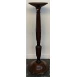 A mahogany pot stand with moulded top on octagonal column and turned base with three ball feet,