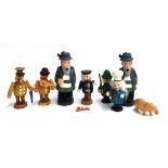 A collection of seven handmade German wooden figurines; together with a carved wooden hippo (8)