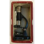 A vintage children's microscope, with two slides, in original box
