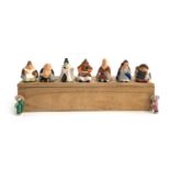 A wooden box containing 9 small Chinese ceramic figurines, each approx. 2cmH