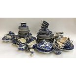 A very large collection of blue and white Willow pattern dinnerware and teaware, to include