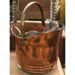 A small copper and brass coal scuttle