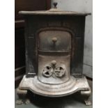 A French cast iron stove with grate and piping, 70cmH