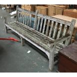 An oak garden bench, 244cm long, one lath missing