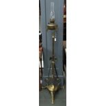 An unusual Art Nouveau standing brass cathedral oil lamp, with glass chimney, adapted for electrical