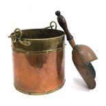 A copper and brass coal scuttle, 26cmH; together with a coal shovel with turned wood handle