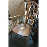 An Ercol beech and elm Chairmakers stickback open armchair