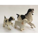 A Belleek figurine of an Irish Setter, marked to base; together with two figurines of Spaniels (3)