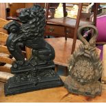 Two cast iron door stops, one in the form of lion mask, the other in the form of a lion rampant