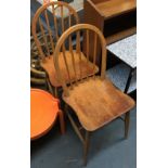 A pair of Ercol style stick back beechwood kitchen chairs