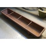 A cast iron feed trough, 90cmL