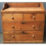 A small pine chest of drawers, with three-quarter gallery top, above two short over two long