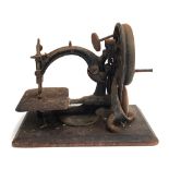 A Willcox and Gibbs sewing machine on wooden base