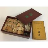 A 20th century Chinese Mahjong set in wooden hardwood box with bamboo game pieces; together with a