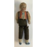 A very small early 20th century bisque doll of a young boy, with fabric torso, marked 'Germany' on