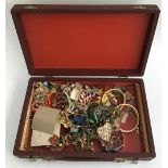 Box (red) of costume jewellery to include brooches, bangles and others