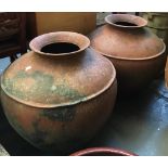 A pair of composite terracotta style garden urns, each 60cmH