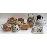 A lot of various teapots, some novelty, several butter dishes, etc, to include Cardew, Arthur