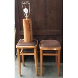 A pair of beechwood stools, together with a cylindrical wooden table lamp