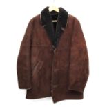 A dark sheepskin jacket; together with one other (2)